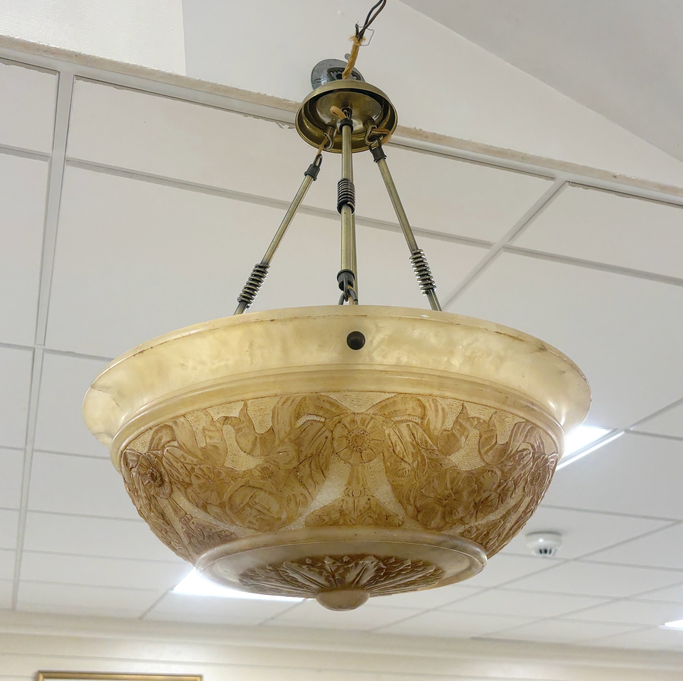 An early 20th century sculpted alabaster and brass plafonnier with four lamp fittings, diameter 46cm